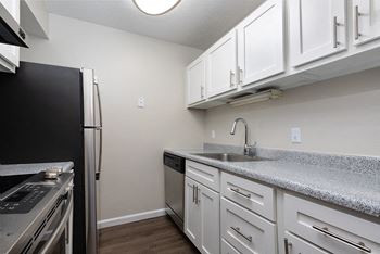 White Cabinetry with Light Grey Stone Countertops